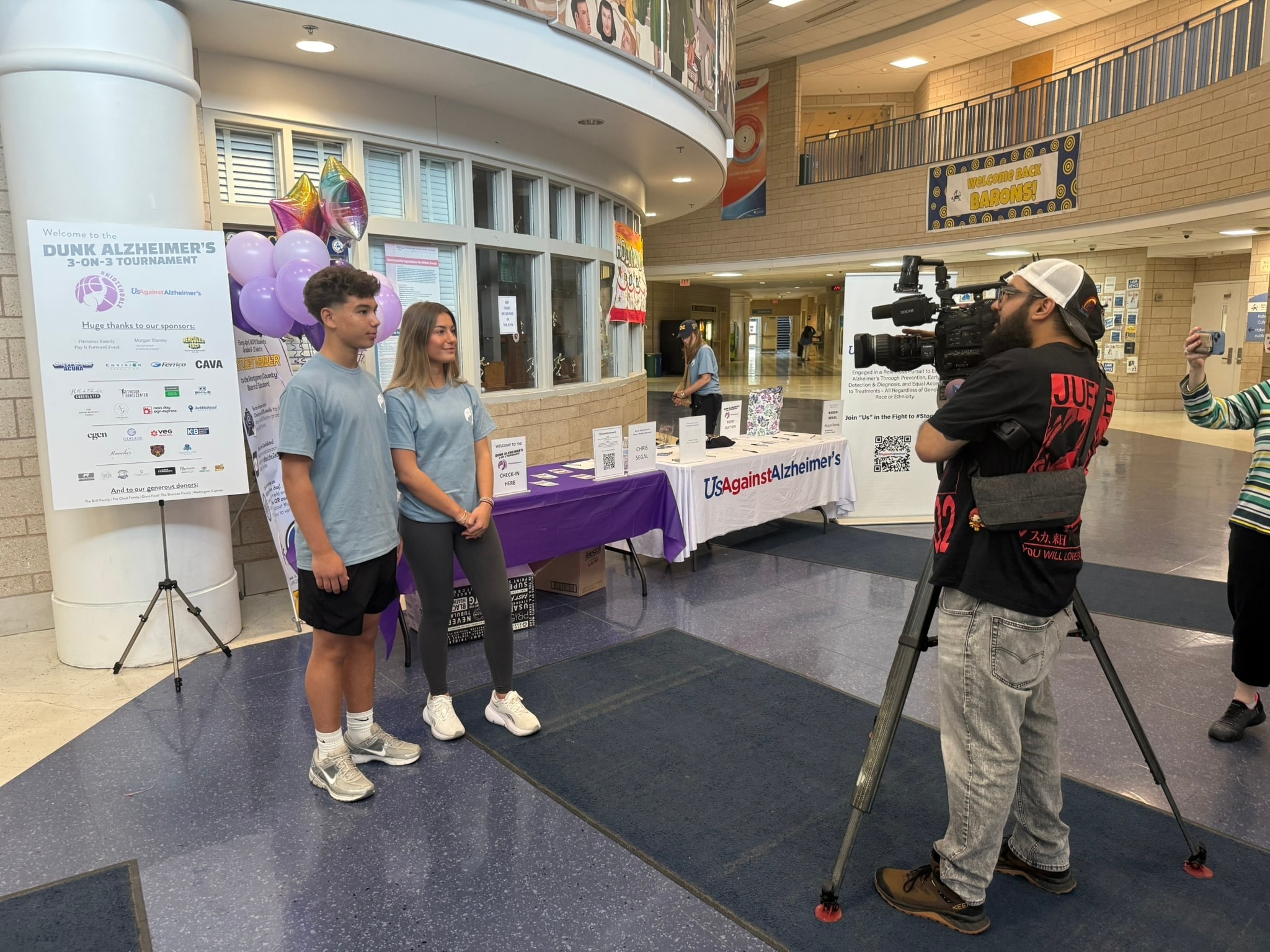 Volunteers and players at the Dunk Alzheimer's check-in booth